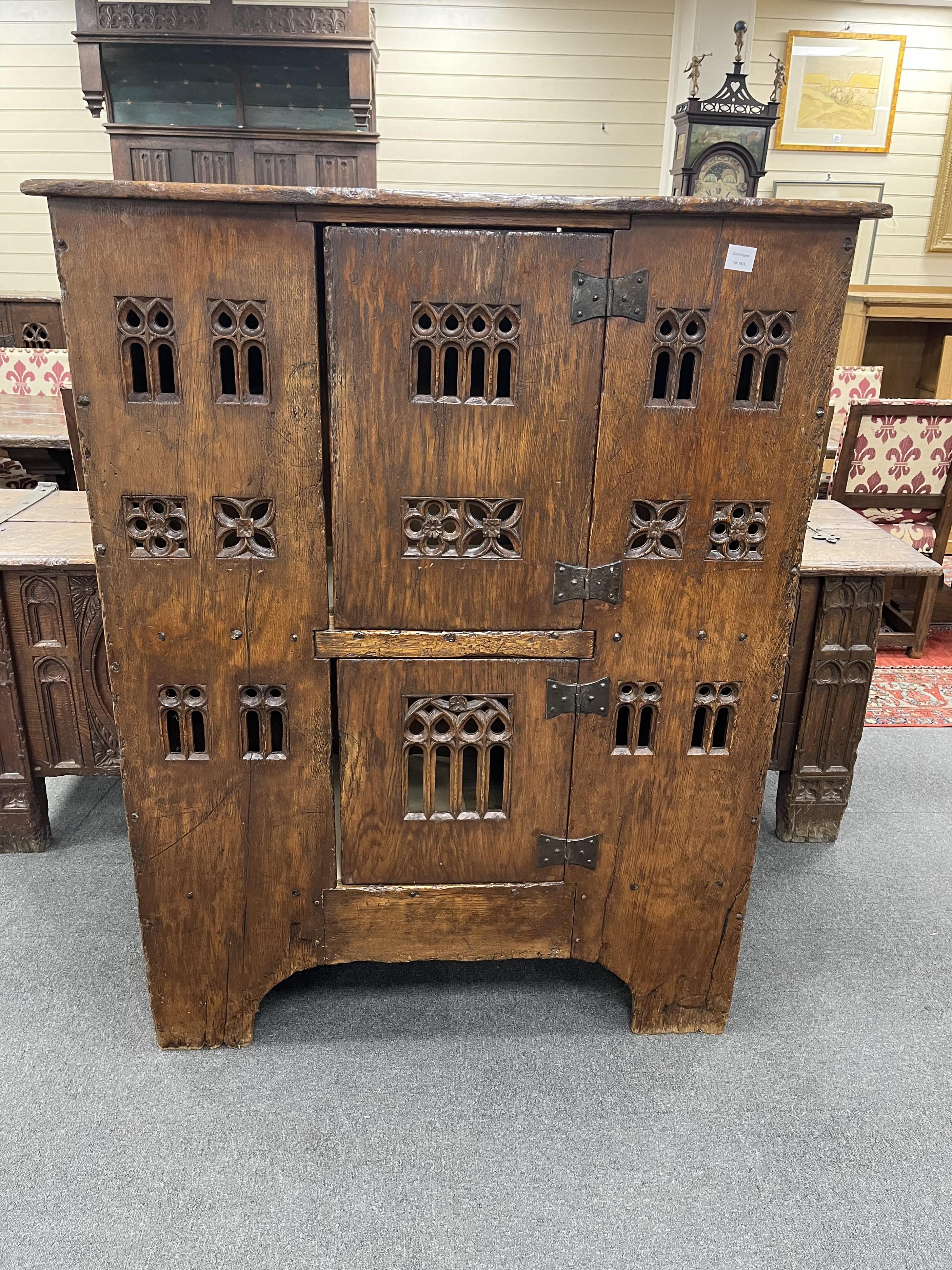 A large Gothic oak aumbry, in late 15th century style, with pierced fretwork panels, width 118cm, depth 53cm, height 151cm. Condition - good, Provenance - made for Brede Place, Brede, Rye, East Sussex. Commissioned from